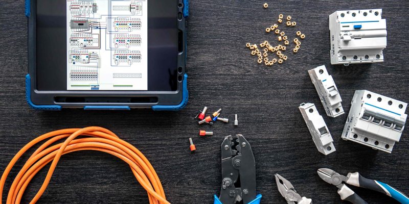 different-electrical-tools-digital-tablet-wooden-background-flat-lay
